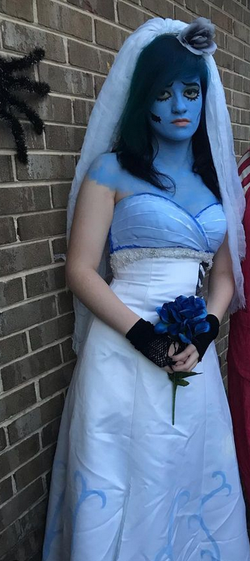 Trinity Coblentz dressed as the Corpse Bride with blue flowers in her hands