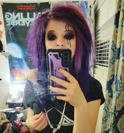 Rocker girl purple teased hair, dark edgy makeup, lightning bolts accenting eye, nose ring, selfie